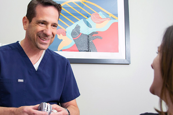 dentist-near-bryn-mawr Dr. Andrew Lieberman discussing dental care with a patient